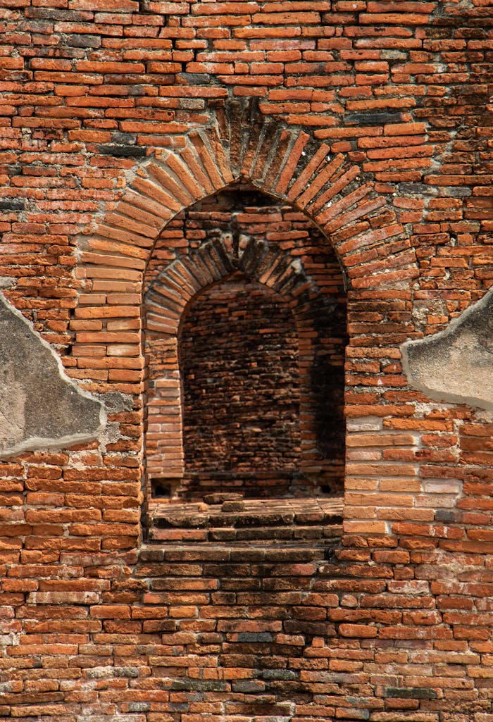 A scenic view of an ancient brick archway with rich textures and historical charm.
